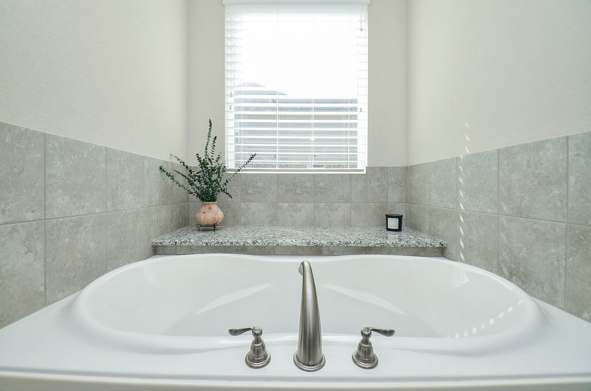 2714 Topaz Cove Lane Rosharon, TX 77583 - Photo 28 of 50 a white bath tub sitting in a bathroom next to a window