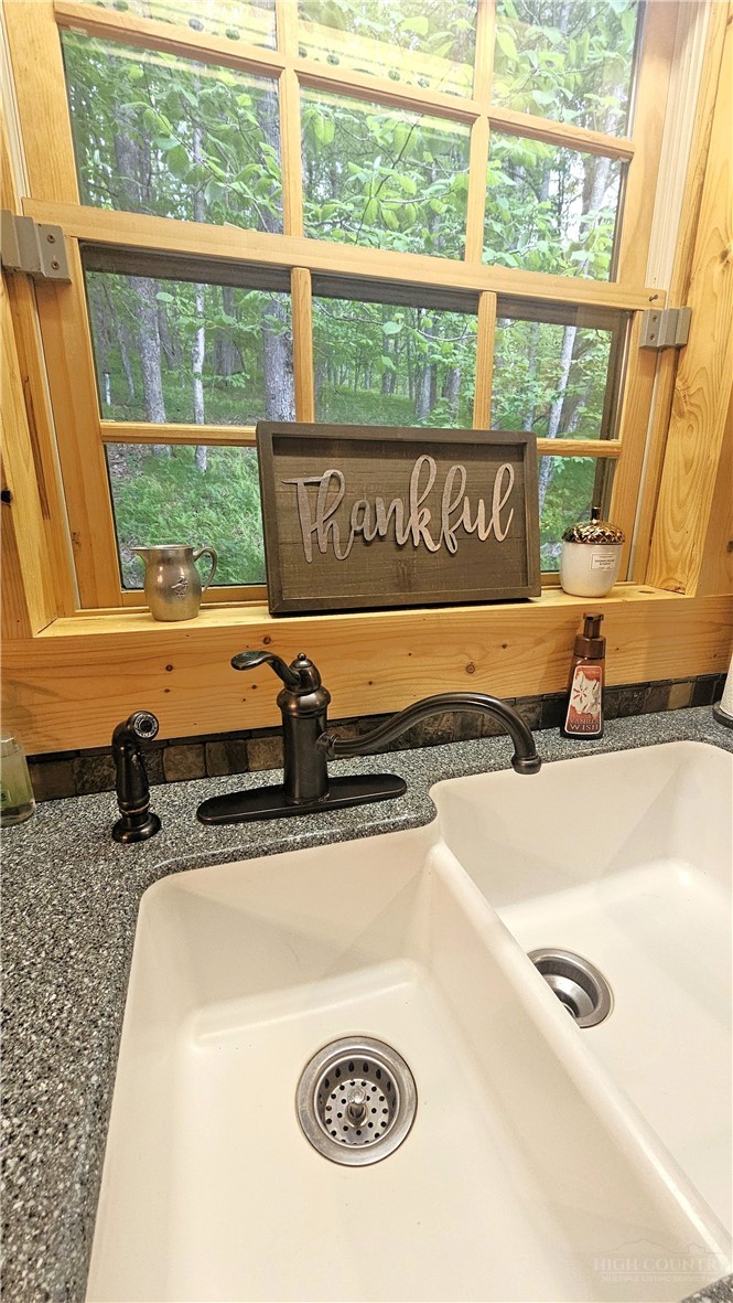 3043 Junaluska Road Boone, NC 28607 - Photo 13 of 49 a bathroom with a granite countertop sink and a large window