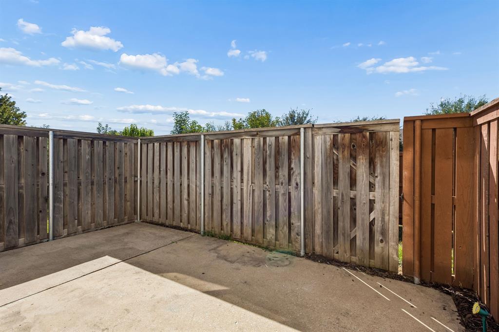 706 South Jupiter Road, Unit 307 Allen, TX 75002 - Photo 30 of 32 Concrete patio with privacy fencing and a dedicated gate