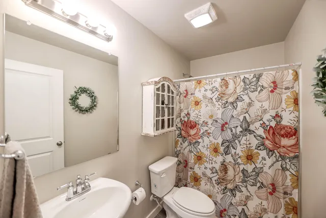 a white toilet sitting next to a bathroom sink