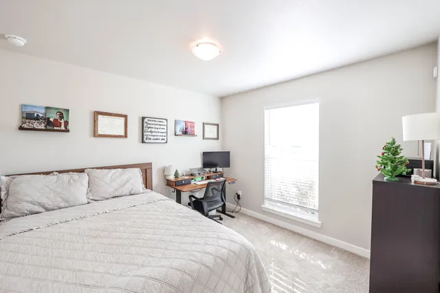 a bedroom with a bed and a window