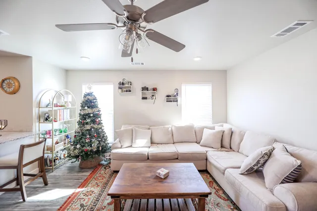 a living room with furniture and a chandelier