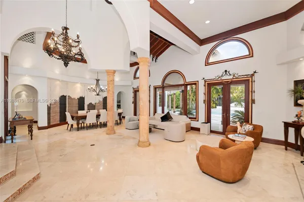 a living room with furniture and large windows