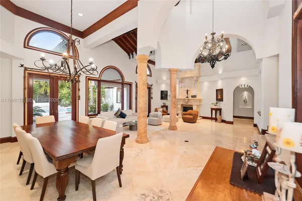 a view of a dining room with furniture and chandelier