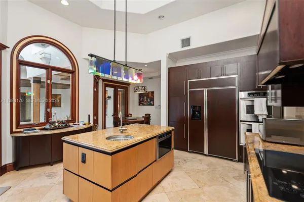 a kitchen with a stove a refrigerator and a sink