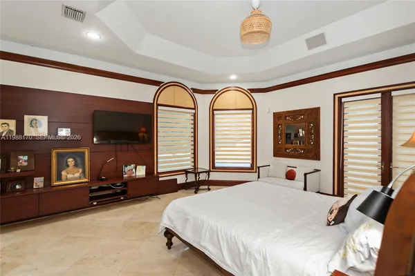 a bedroom with a bed and a chandelier