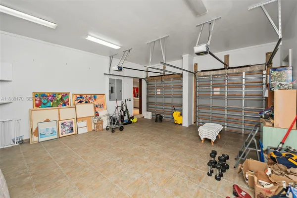a bedroom with a bed couch and a ceiling fan