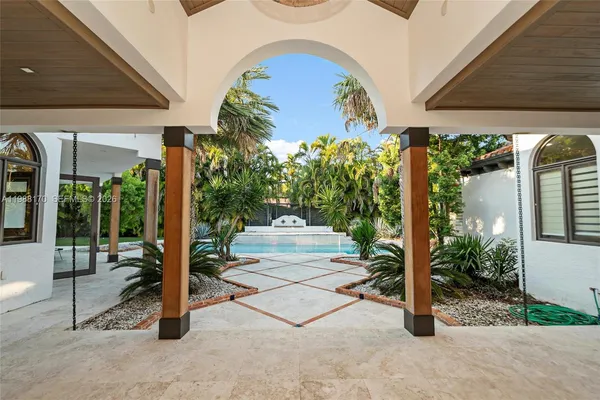 a view of a porch with furniture and a yard