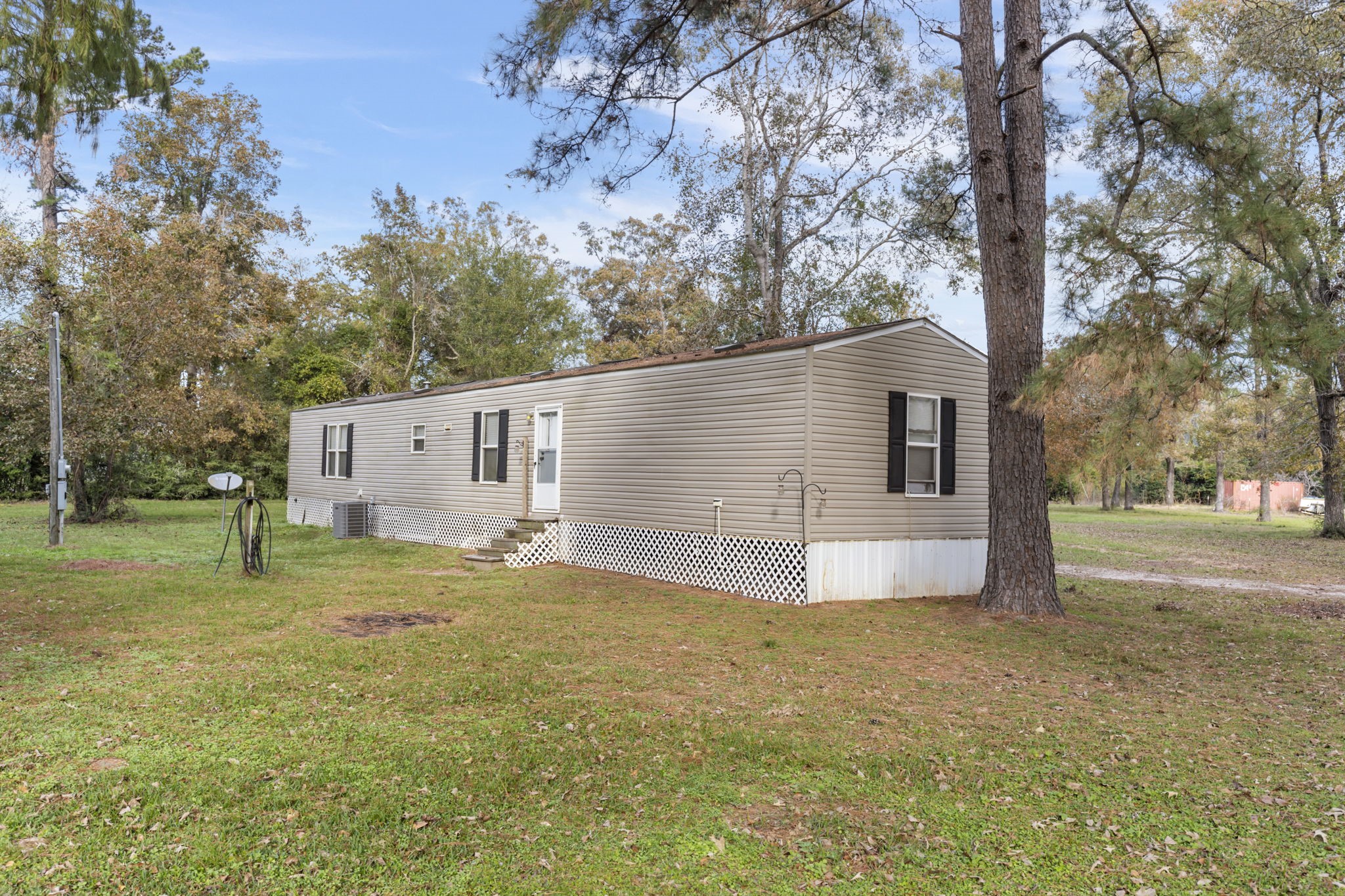11454 Bonney Conroe, TX 77385 - Photo 6 of 27 a white house that has a tree in front of it