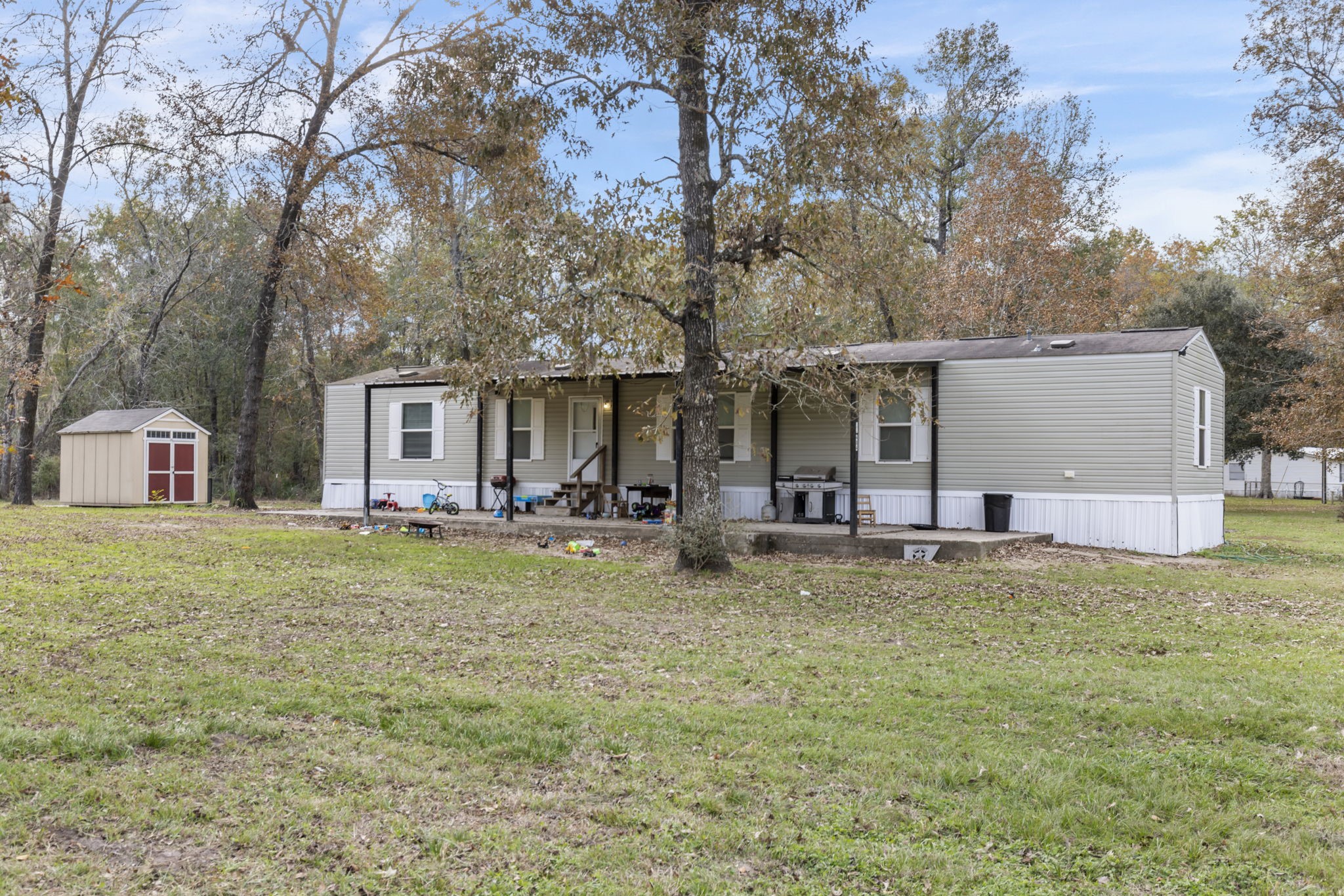 11454 Bonney Conroe, TX 77385 - Photo 8 of 27 a backyard of a house with table and chairs and potted plants