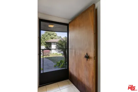 a view of a hallway with a window and a yard