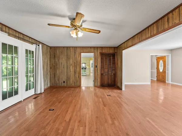 a living room with a wooden floor and a fireplace