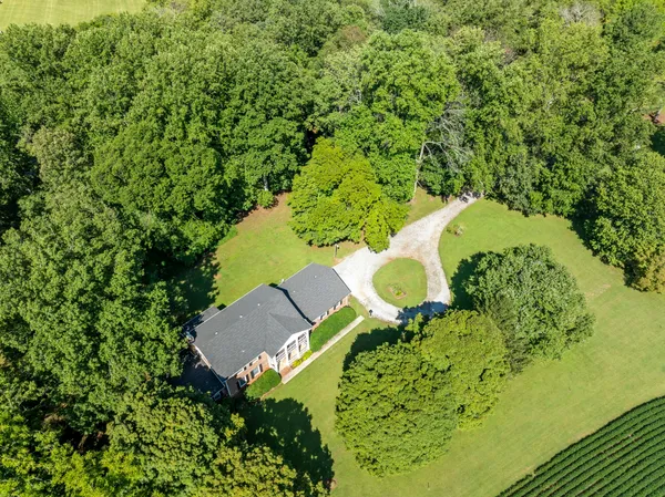 an aerial view of a house with a yard and garden