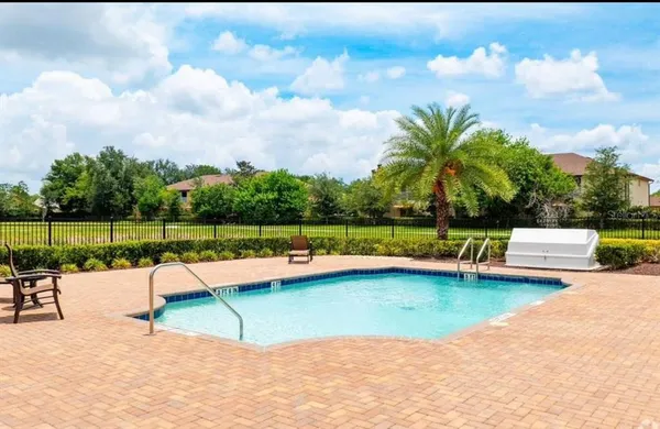 a view of swimming pool with a garden and trees