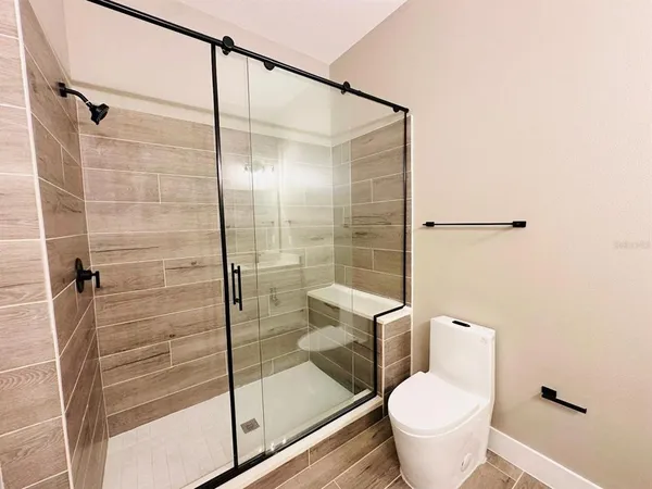 a bathroom with a shower and toilet
