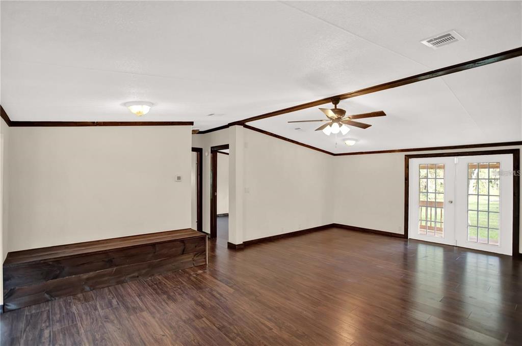 10650 Northwest 190th Street Micanopy, FL 32667 - Photo 11 of 31 an empty room with wooden floor and windows
