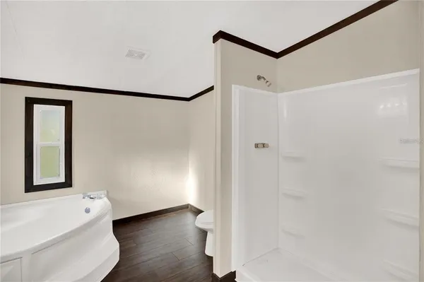a view of a bathroom with a tub and shower