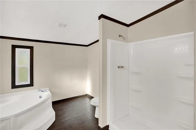 a view of a bathroom with a tub and shower