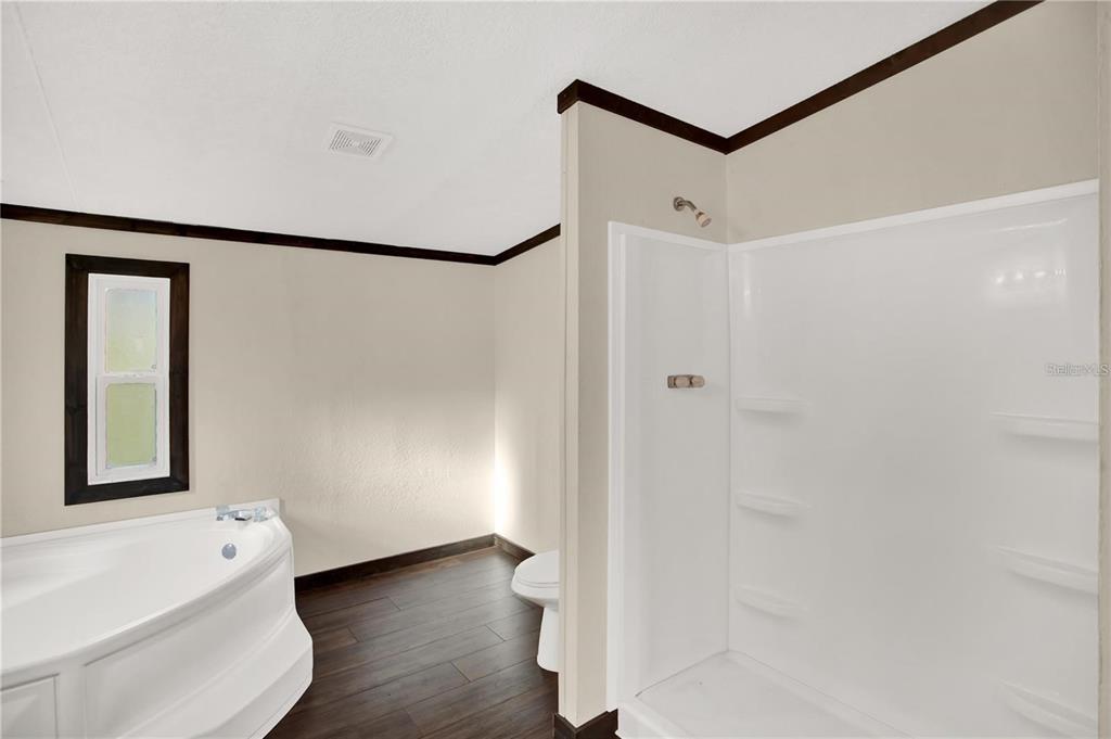 10650 Northwest 190th Street Micanopy, FL 32667 - Photo 14 of 31 a view of a bathroom with a tub and shower
