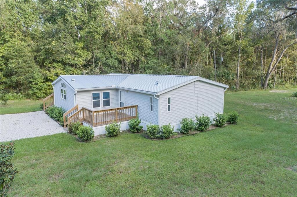 10650 Northwest 190th Street Micanopy, FL 32667 - Photo 2 of 31 a aerial view of a house next to a big yard and large trees