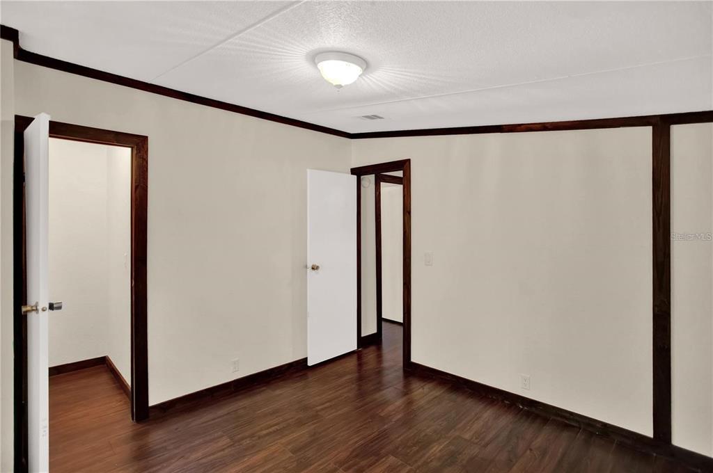 10650 Northwest 190th Street Micanopy, FL 32667 - Photo 24 of 31 an empty room with wooden floor and a window