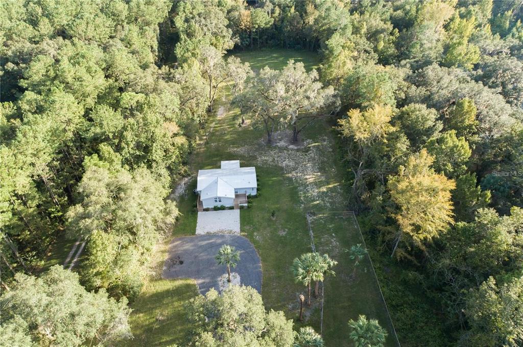 10650 Northwest 190th Street Micanopy, FL 32667 - Photo 30 of 31 a bird view of a house with a yard and large trees