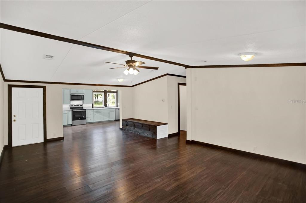 10650 Northwest 190th Street Micanopy, FL 32667 - Photo 3 of 31 a view of an empty room with wooden floor and a window