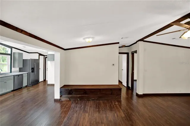 wooden floor in an empty room with a window
