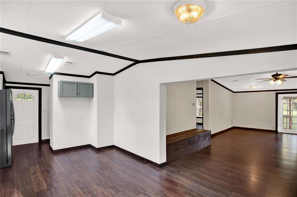 10650 Northwest 190th Street Micanopy, FL 32667 - Photo 10 of 31 a view of an empty room with wooden floor and a window