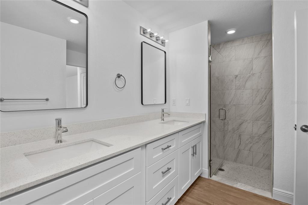 4529 Rhapsody Avenue North Port, FL 34288 - Photo 6 of 10 a bathroom with a double vanity sink mirror and shower