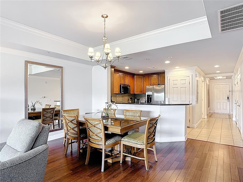 1356 Centre Ct Ridge Drive, Unit 103 Reunion, FL 34747 - Photo 14 of 53 a view of a dining room and livingroom with furniture wooden floor a chandelier