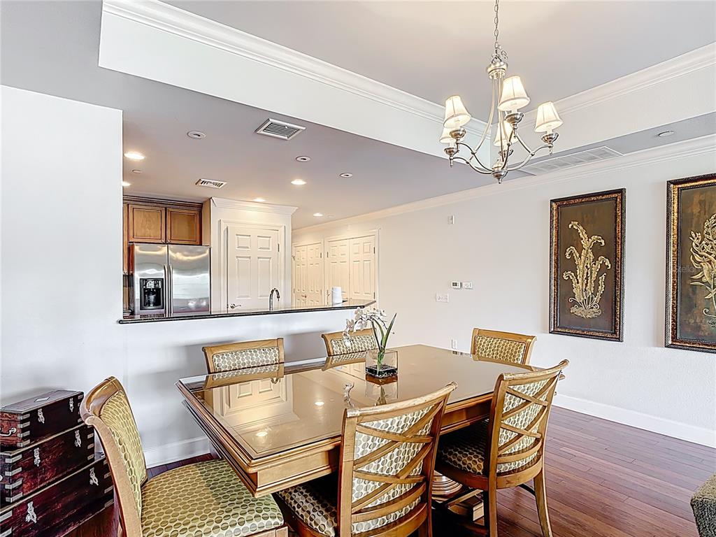 1356 Centre Ct Ridge Drive, Unit 103 Reunion, FL 34747 - Photo 15 of 53 a view of a dining room with furniture and chandelier