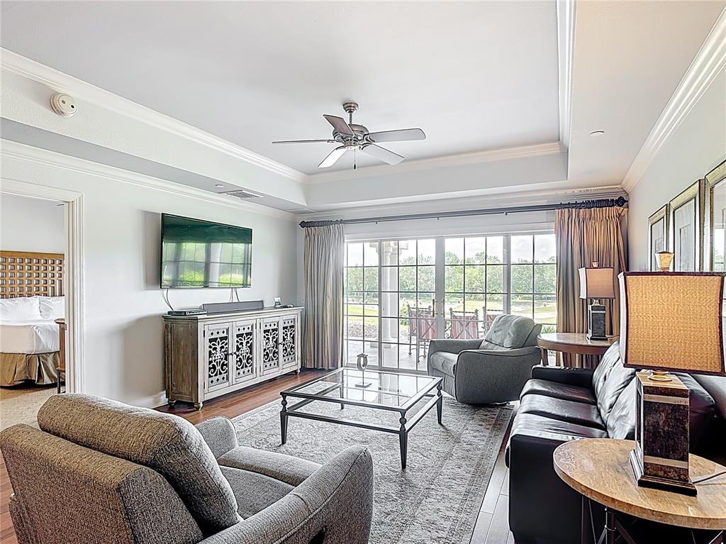1356 Centre Ct Ridge Drive, Unit 103 Reunion, FL 34747 - Photo 16 of 53 a living room with furniture a flat screen tv and a window