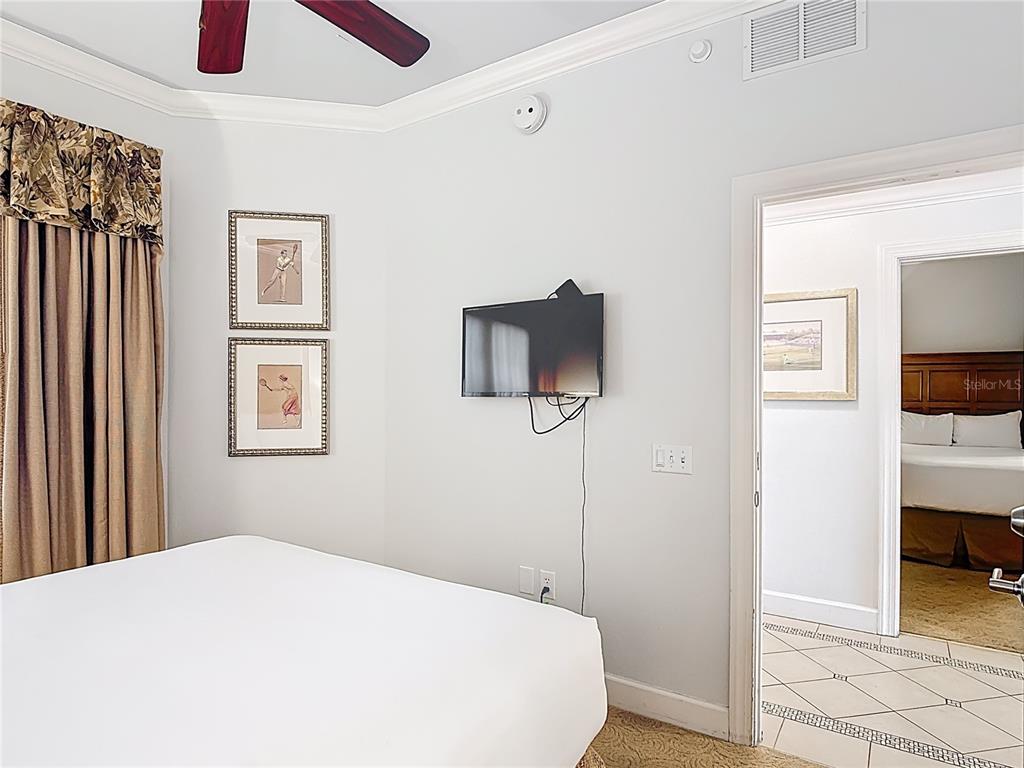 1356 Centre Ct Ridge Drive, Unit 103 Reunion, FL 34747 - Photo 20 of 53 a bedroom with a bed and a tv