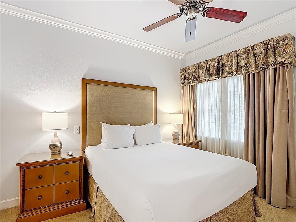 1356 Centre Ct Ridge Drive, Unit 103 Reunion, FL 34747 - Photo 21 of 53 a bedroom with a bed and a chandelier