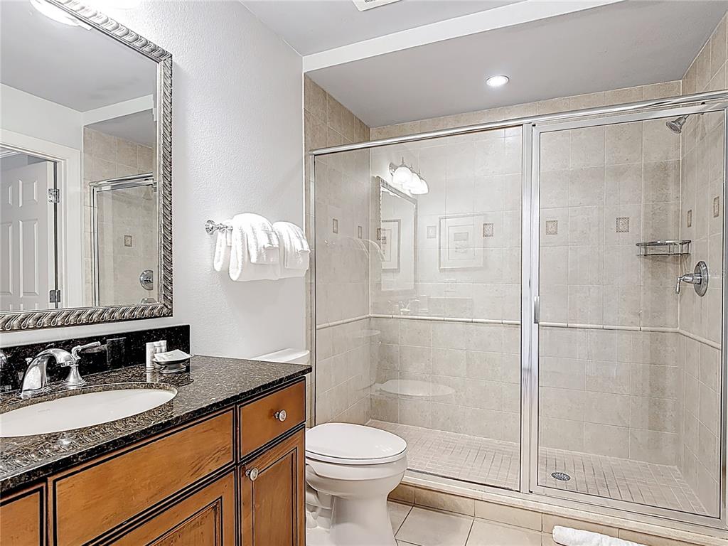 1356 Centre Ct Ridge Drive, Unit 103 Reunion, FL 34747 - Photo 23 of 53 a bathroom with a granite countertop sink toilet and shower