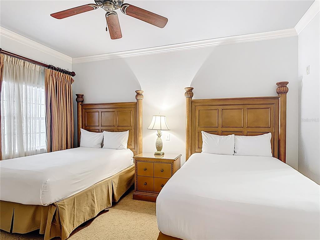 1356 Centre Ct Ridge Drive, Unit 103 Reunion, FL 34747 - Photo 26 of 53 a bedroom with a bed and wooden floor