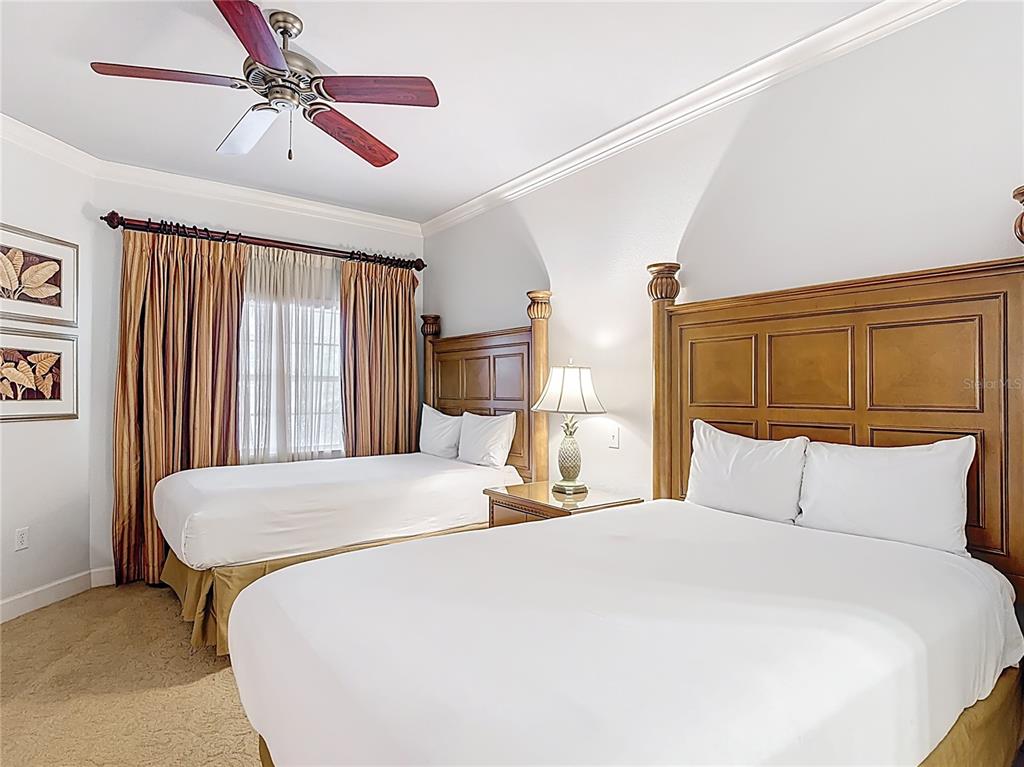 1356 Centre Ct Ridge Drive, Unit 103 Reunion, FL 34747 - Photo 27 of 53 a bedroom with a large bed and a chandelier