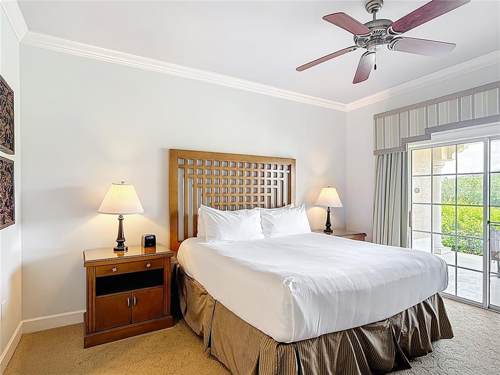 1356 Centre Ct Ridge Drive, Unit 103 Reunion, FL 34747 - Photo 33 of 53 a bedroom with a bed and a lamp