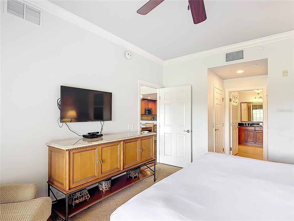 1356 Centre Ct Ridge Drive, Unit 103 Reunion, FL 34747 - Photo 34 of 53 a bedroom with furniture and flat screen tv