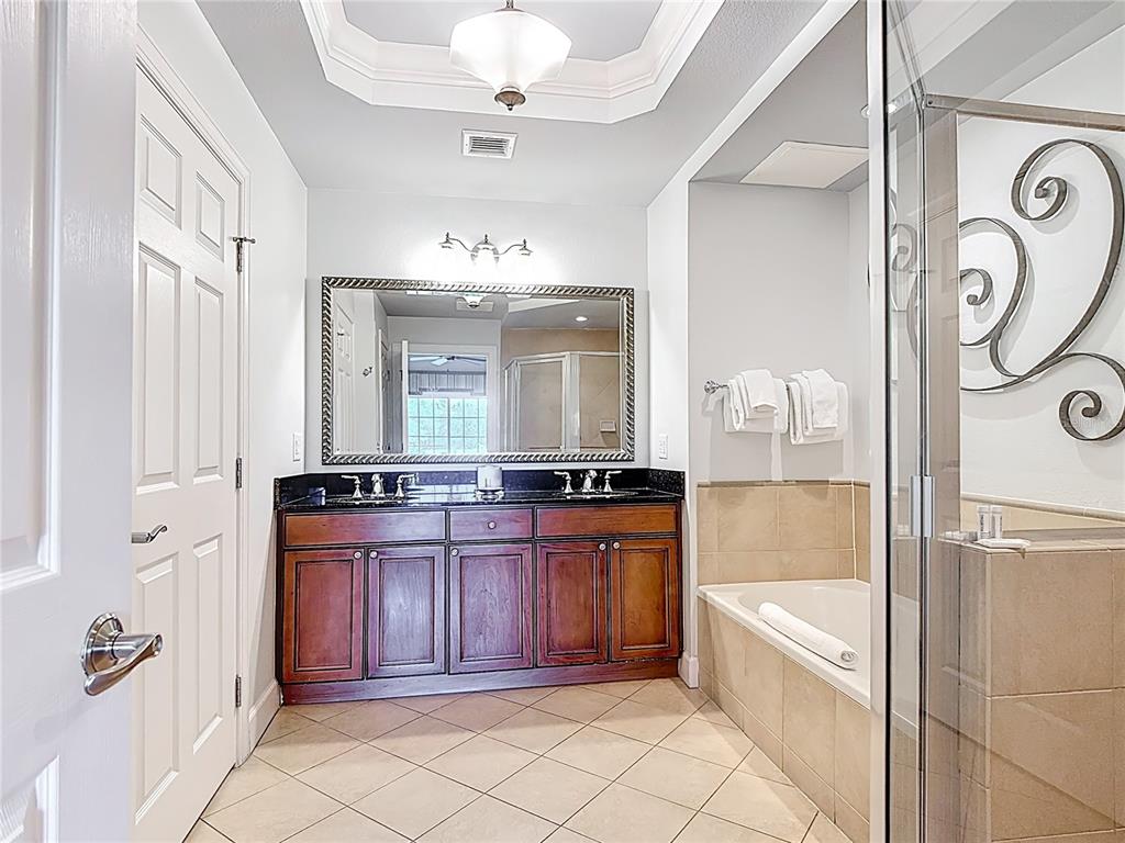 1356 Centre Ct Ridge Drive, Unit 103 Reunion, FL 34747 - Photo 35 of 53 a large spacious bathroom with a tub sink and mirror