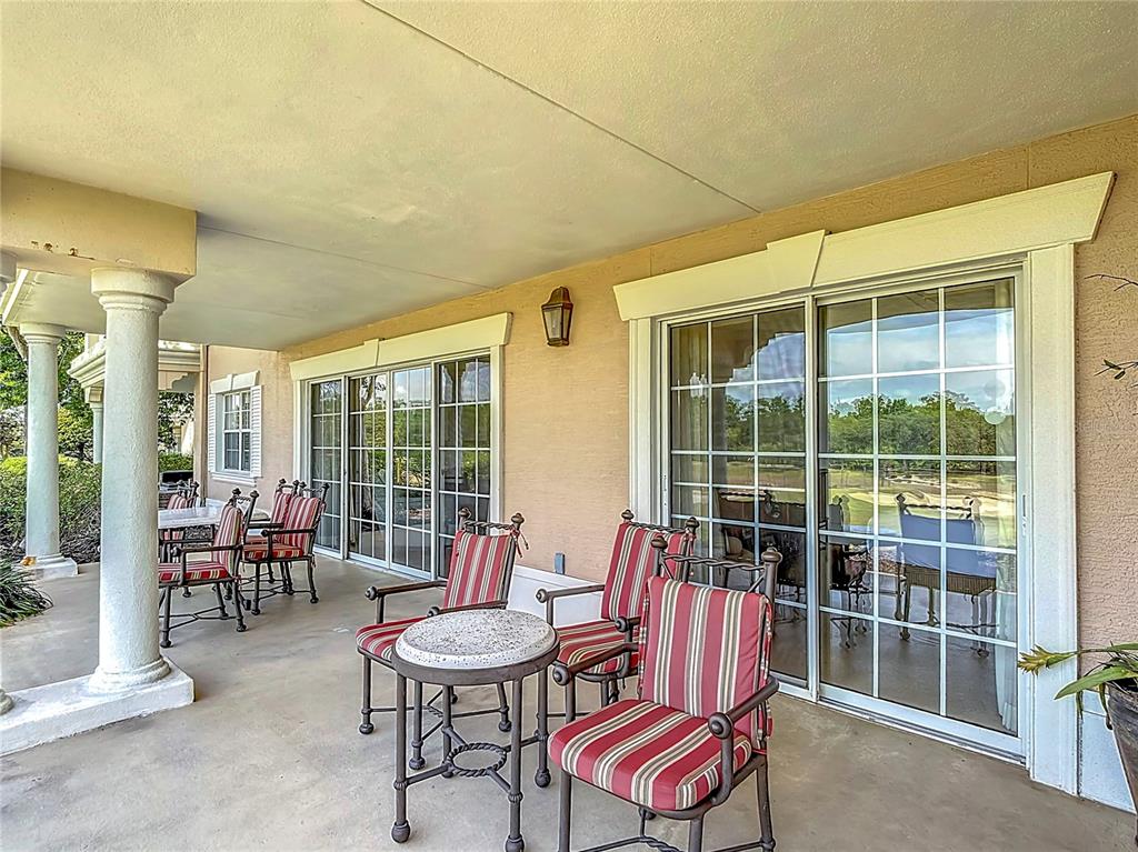 1356 Centre Ct Ridge Drive, Unit 103 Reunion, FL 34747 - Photo 42 of 53 a balcony with chairs and table