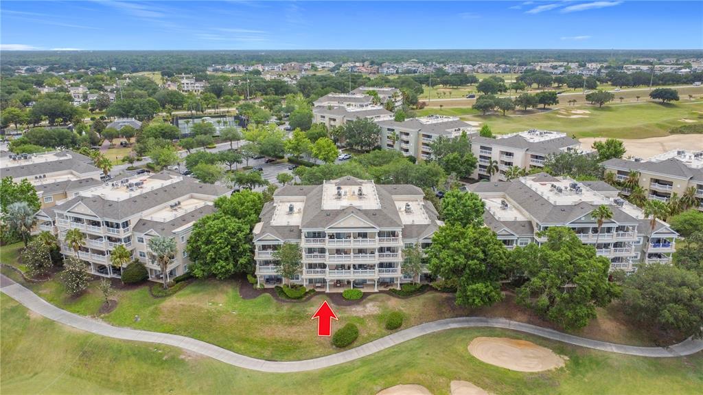 1356 Centre Ct Ridge Drive, Unit 103 Reunion, FL 34747 - Photo 49 of 53 an aerial view of residential houses with outdoor space and swimming pool