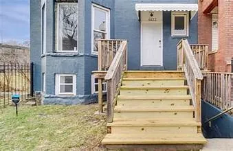 a view of staircase with white walls and a window
