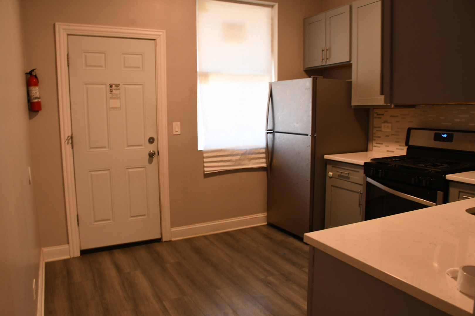 6522 South Ellis Avenue, Unit 1 Chicago, IL 60637 - Photo 2 of 5 a kitchen with stainless steel appliances a refrigerator and a stove