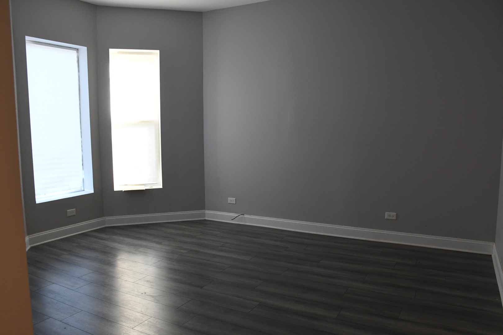 6522 South Ellis Avenue, Unit 1 Chicago, IL 60637 - Photo 5 of 5 a view of an empty room with wooden floor and a window