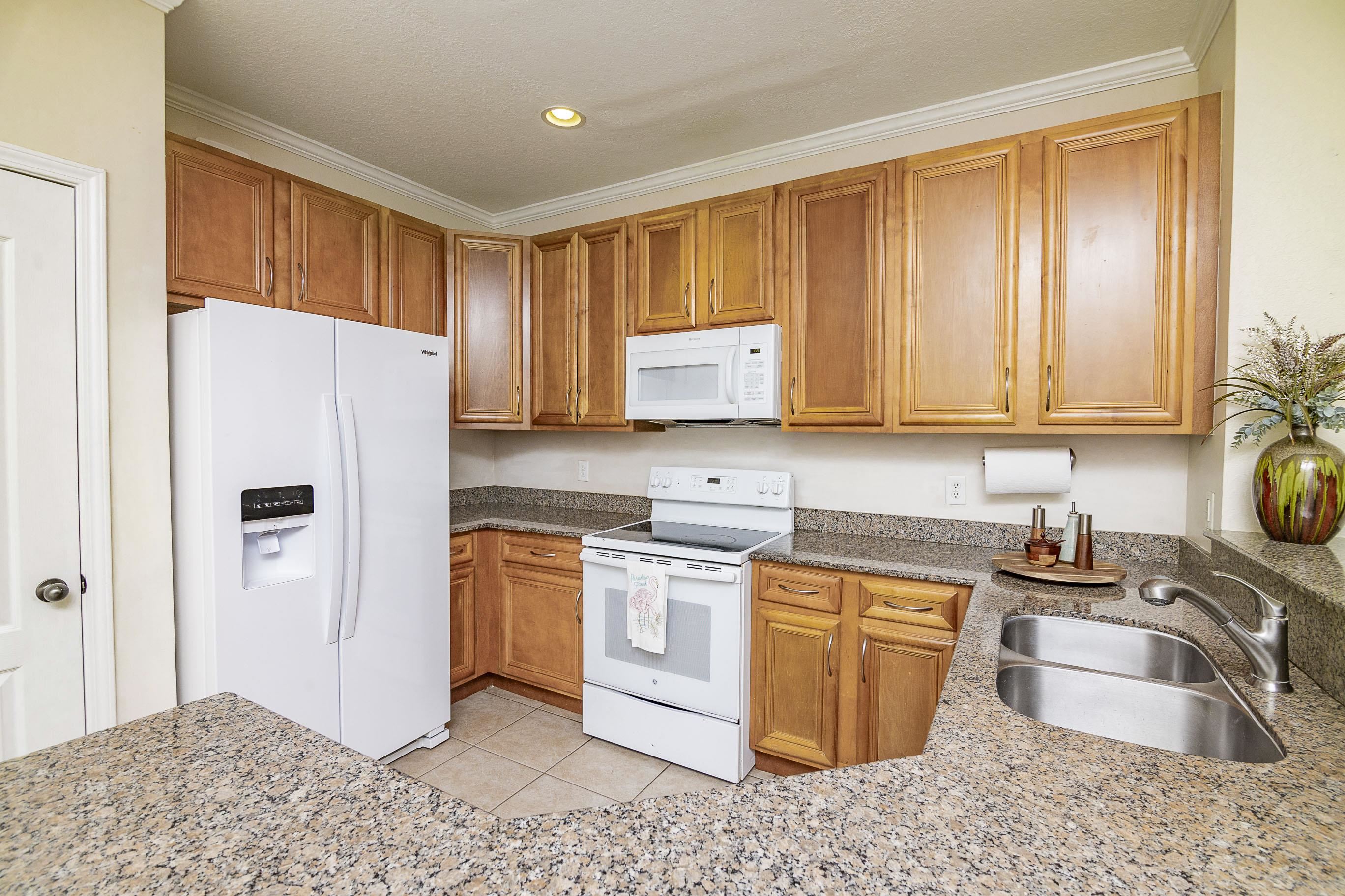 175 Bayberry Circle, Unit 1008 St. Augustine, FL 32086 - Photo 11 of 44 a kitchen with stainless steel appliances granite countertop a refrigerator sink and stove