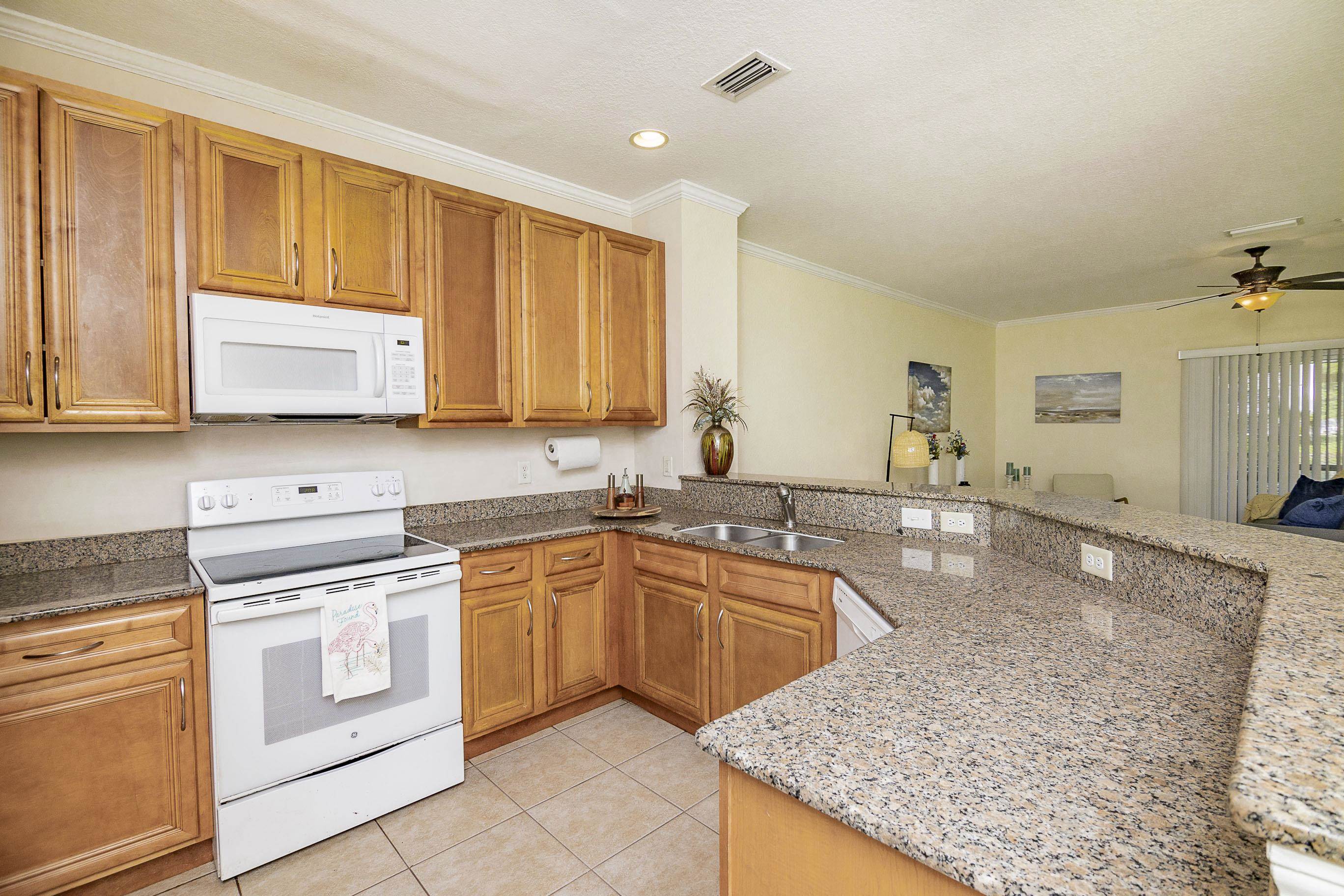175 Bayberry Circle, Unit 1008 St. Augustine, FL 32086 - Photo 12 of 44 a kitchen with stainless steel appliances granite countertop a stove a sink and a microwave