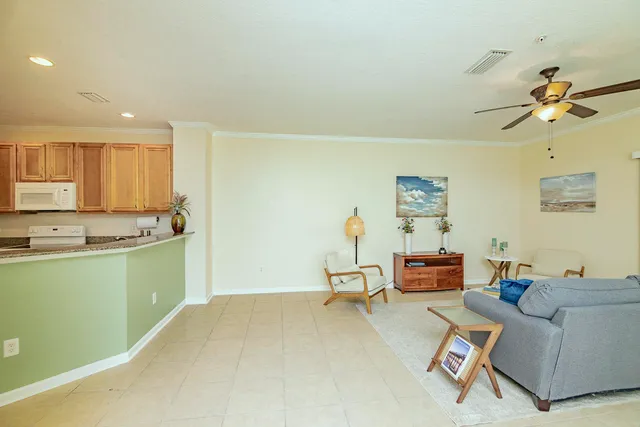 a living room with furniture and a kitchen