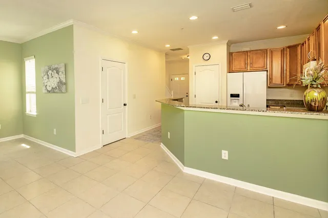 a view of kitchen with stainless steel appliances granite countertop a refrigerator and a sink